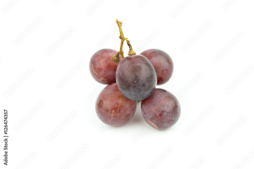 Ripe red grape with leaves isolated on white Ripe red grape with leaves isolated on white