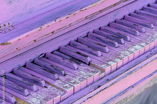 Old piano keys painted in purple. Music