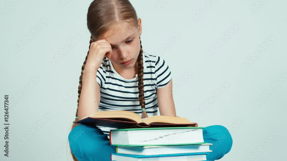 Portrait student girl reading a book sitting on the floor. Zooming Portrait student girl reading a book sitting on the floor. Zooming