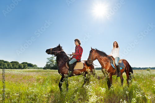 Young couple spending time together riding horses © Sergey Novikov