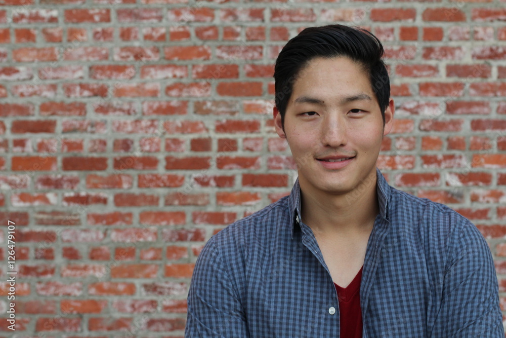 Asian man smiling and laughing with space for copy or text Asian man smiling and laughing with space for copy or text