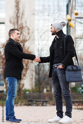 Two happy business people talking with each other in a park