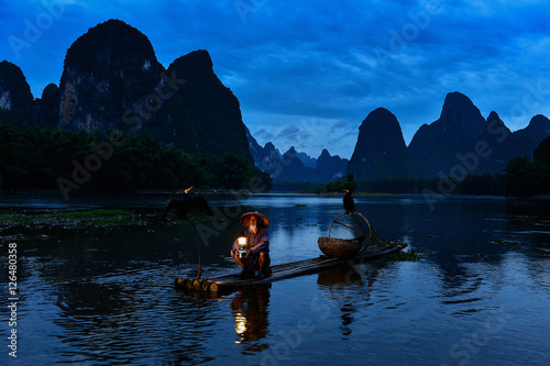 Fisherman of Guilin, Li River and Karst mountains during the blue hour of dawn,Guangxi  China © saravut