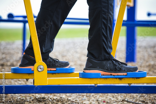 young man working out at outdoor gym