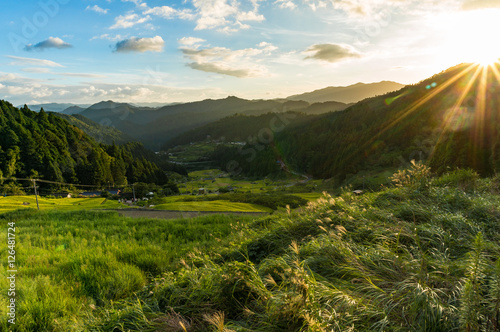 Sunset in the mountains with rice paddy fields and forest