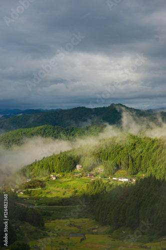 Fototapeta Naklejka Na Ścianę i Meble -  Dramatic landscape of Japanese high mountain village on foggy morning