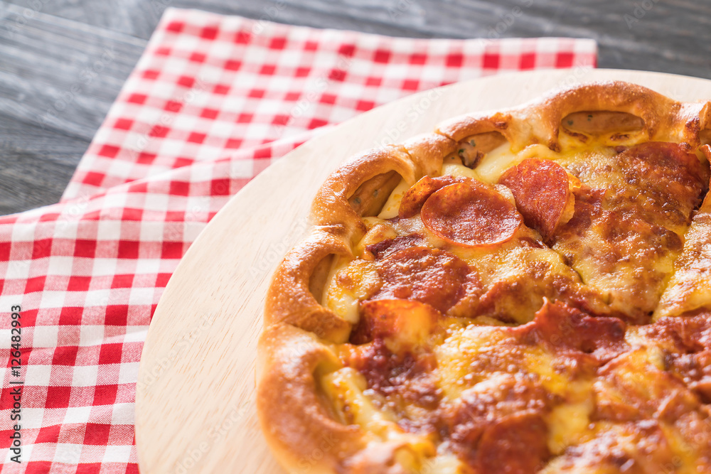 Homemade Pepperoni Pizza on wood plate Homemade Pepperoni Pizza on wood plate