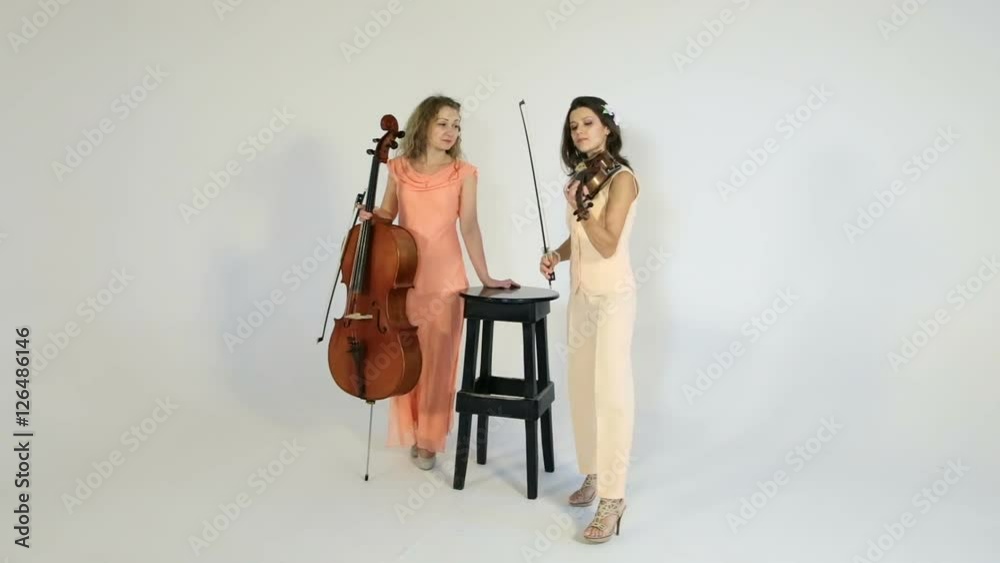 Photoshoot for a fashion magazine. Beautiful sexy girls posing for a photograph. White background. Photoshoot for a fashion magazine. Beautiful sexy girls posing for a photograph. White background.