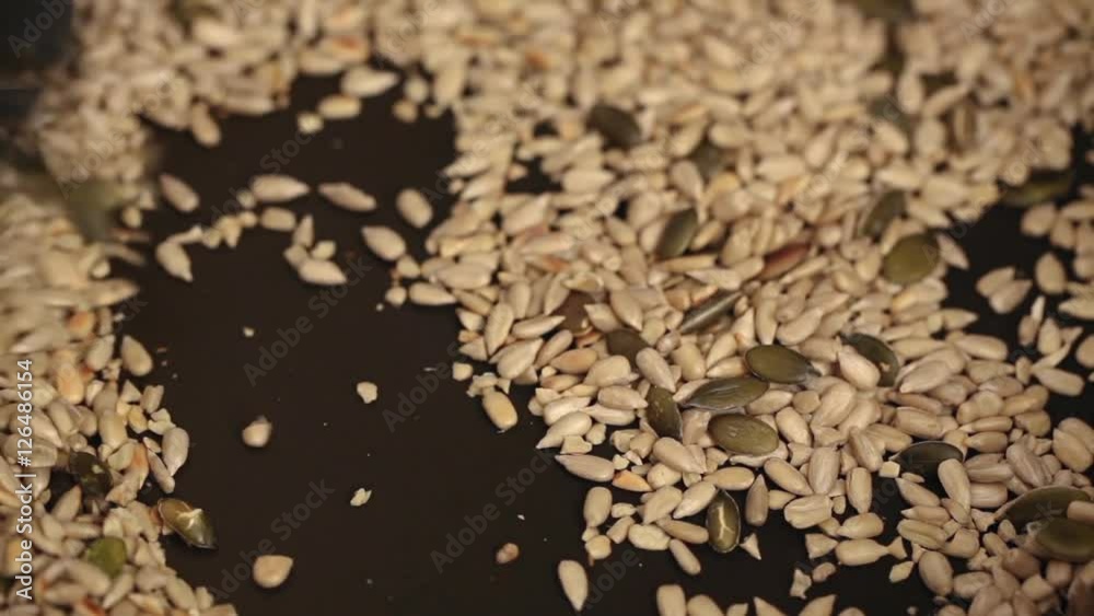 Sunflower and pumpkin seed dry fried in pan; extreme close up; Sunflower and pumpkin seed dry fried in pan; extreme close up;