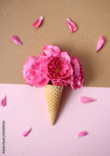 ice cream of pink roses. Roses in a waffle cup on a brown and pink mix background 3