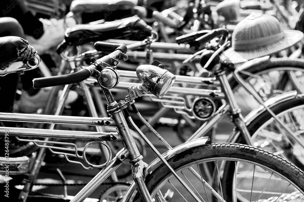 Obraz premium Black and white image of bike taxi parking on street in northern of Thailand
