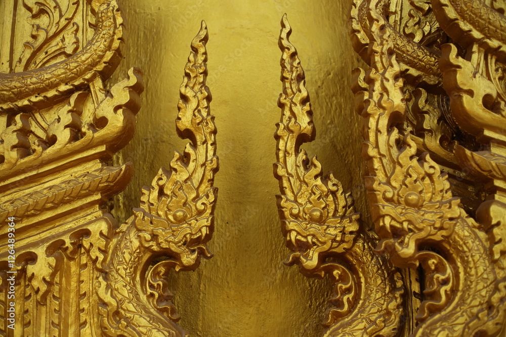 gold color wall of Wat Pak Nam Jolo in Chachoengsao at Thailand.