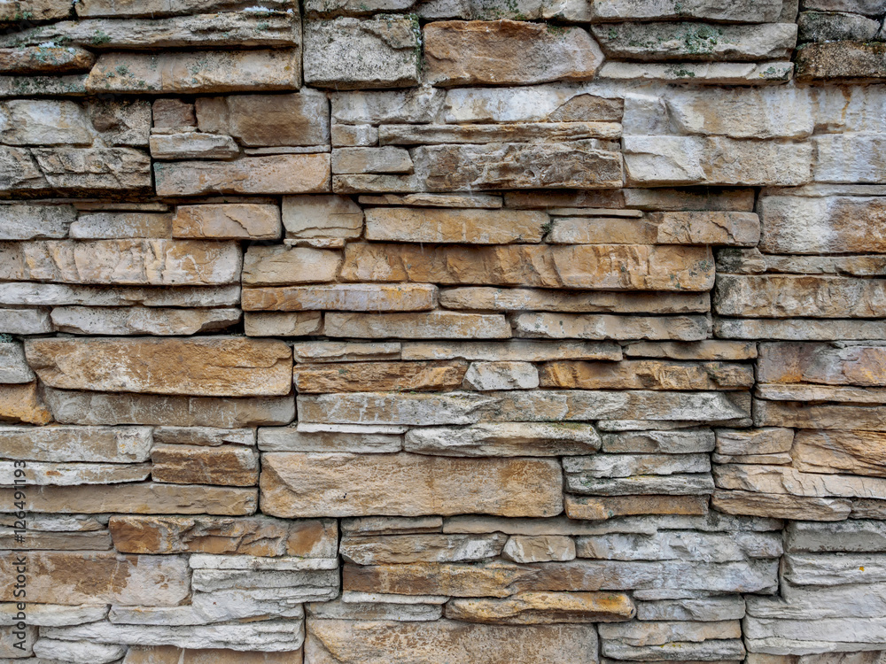 Texture of a stone laying from the gray and yellow stone put in any order.