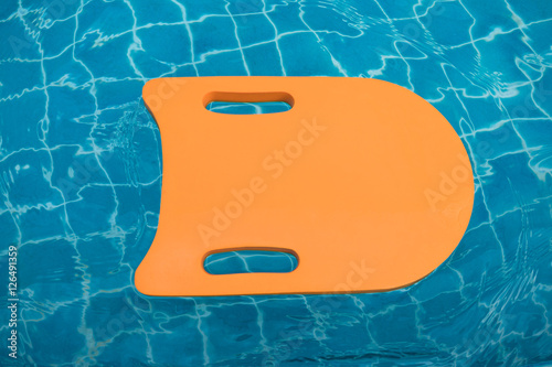 Orange foam board floating in swimming pool