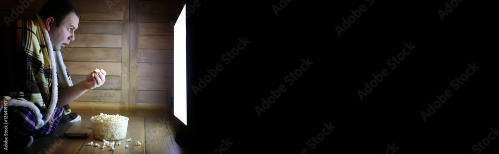 Fototapeta premium man watching television at home on the floor