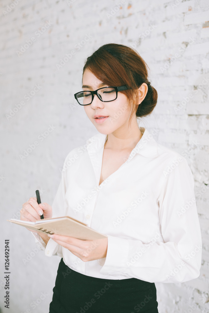 businesswoman writing in her notebook