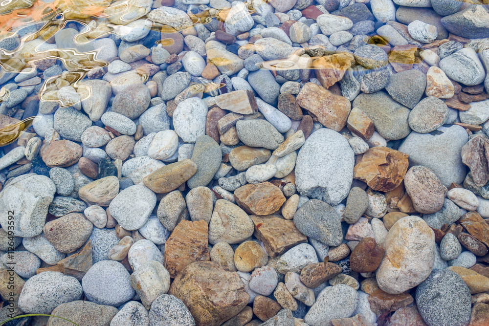 pebbles under the transparent water pebbles under the transparent water