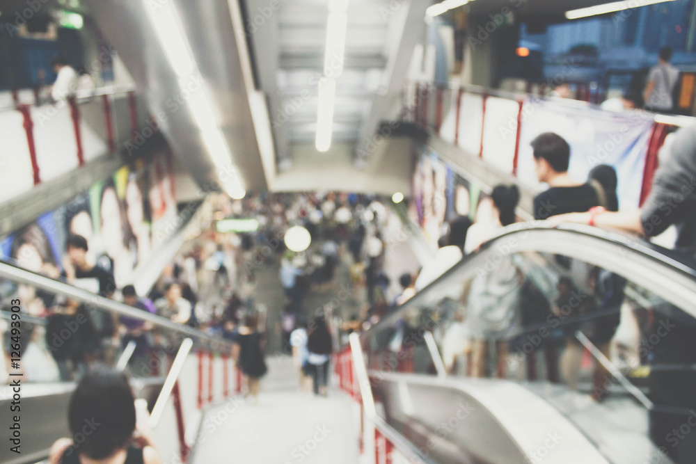 blurred photo of people on escalator..