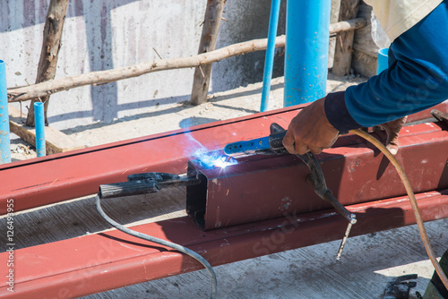 Welder man welding, spark light and hot,Metaliron work steel  photo