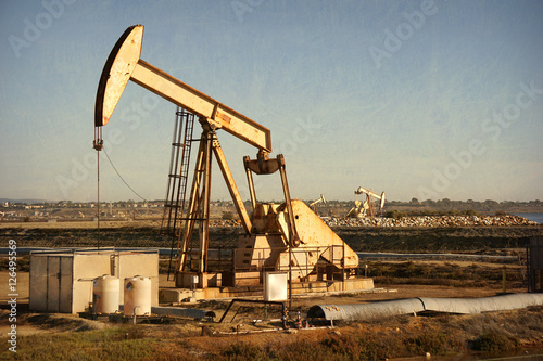 aged and worn vintage of oil derrick photo