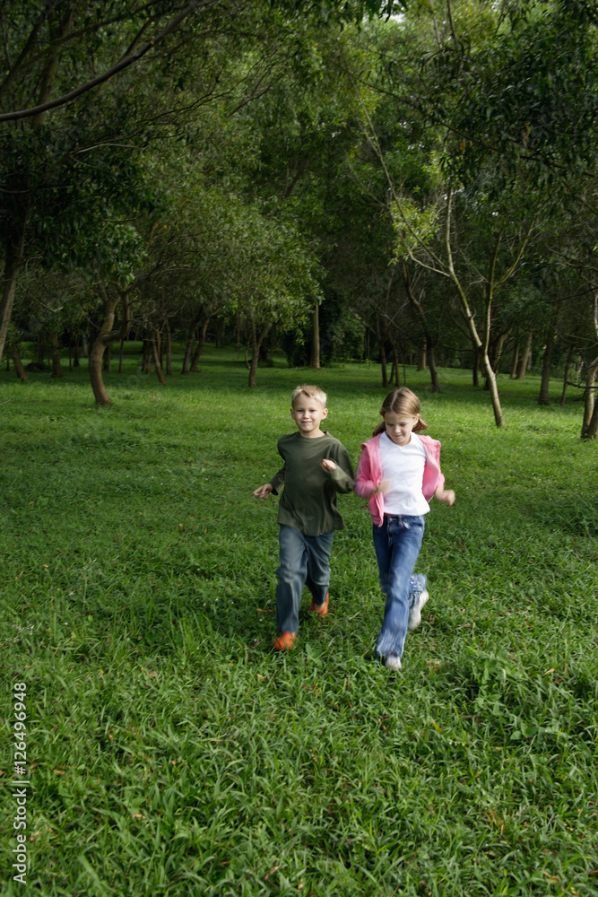 boy and girl running in field
