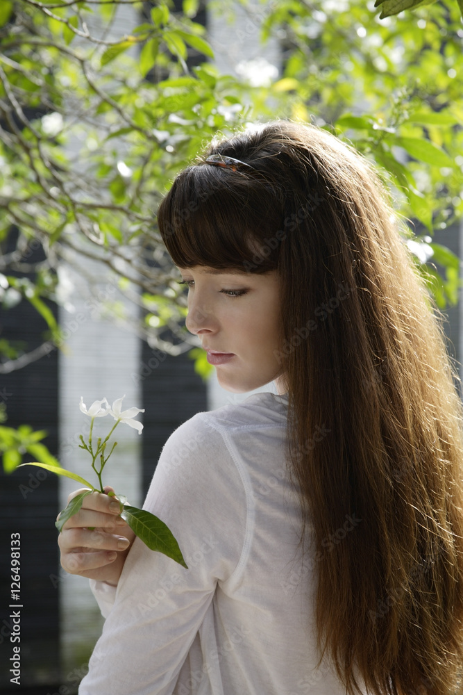 young woman holding flower