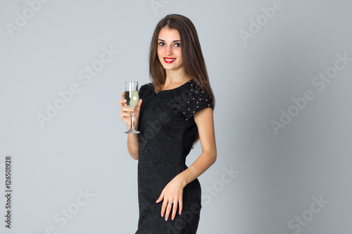 girl in black dress posing in studio