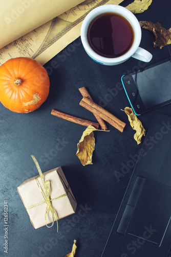 coffee with pumpkin and gift in front of laptop