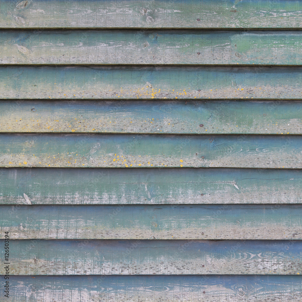 part of shed wall consisting of old wooden planks with faded gre part of shed wall consisting of old wooden planks with faded gre