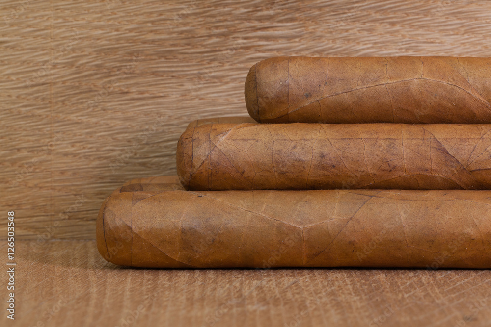 Luxury Cuban cigars on the wooden desk Luxury Cuban cigars on the wooden desk