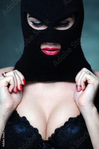girl in bra and balaclava - black and white photo in studio of a psycho girl terrorist photo