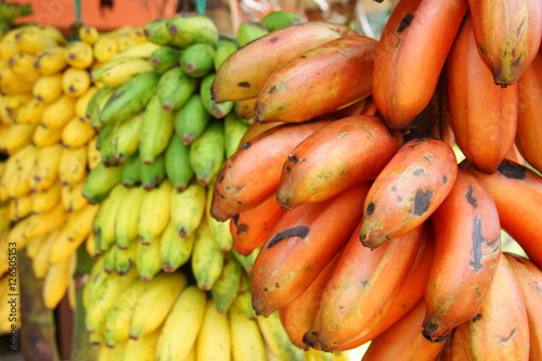 Red, green and yellow banana bunches in a fruit shop along the road (Sri Lanka)