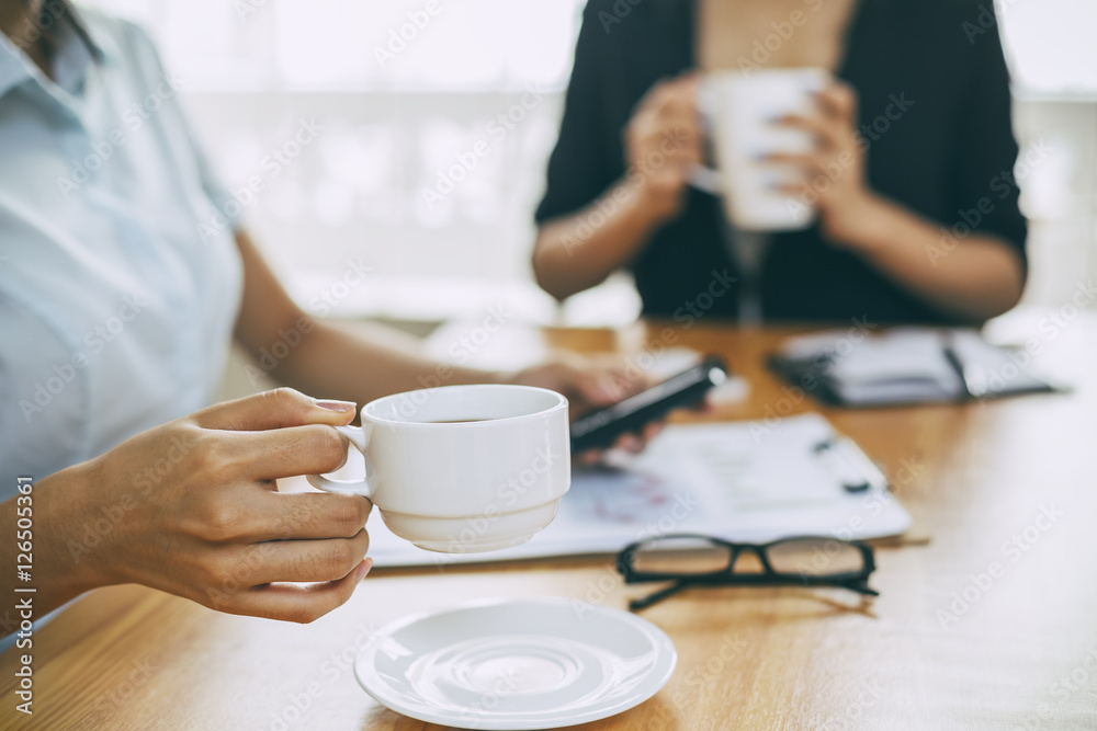 businesswomen working in office with coffee businesswomen working in office with coffee
