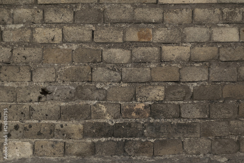 Old broken damaged gray brick wall abstract isolated background texture