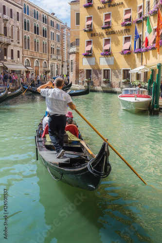 Gondolier rides gondola. © arbalest