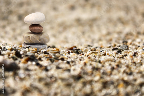 Canvas Print Zen stones on sand background with depth of field
