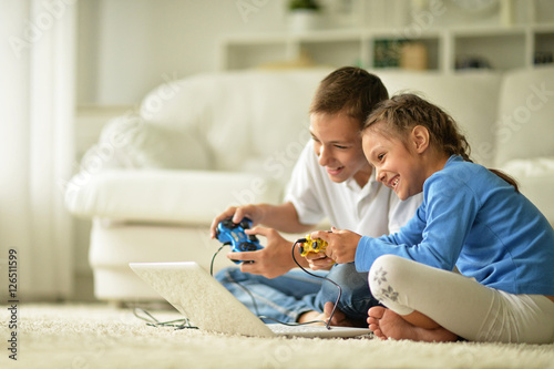 Children with laptop at home