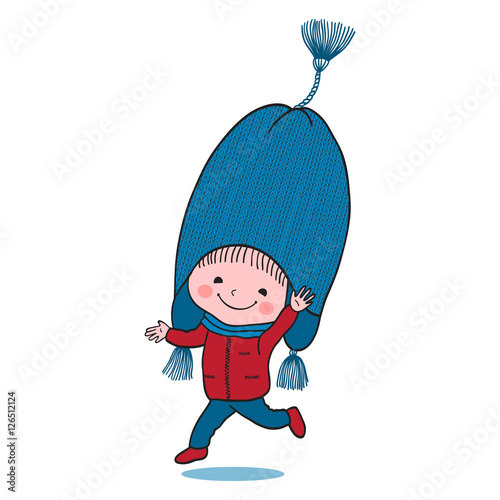 Little jumping boy in big winter knitted cap photo