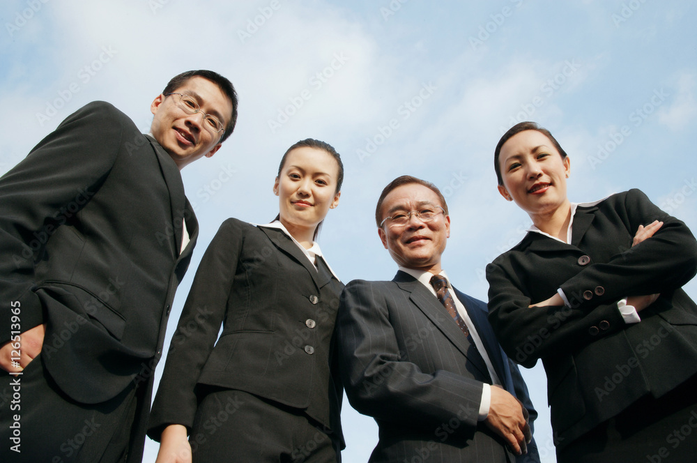Businessmen and businesswomen looking down at camera Businessmen and businesswomen looking down at camera