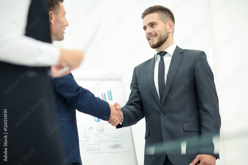 Diversity business team concluding contract with handshake in a Diversity business team concluding contract with handshake in a