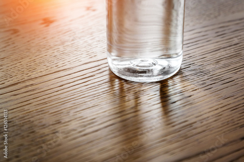 Plastic water bottle on wooden table texture