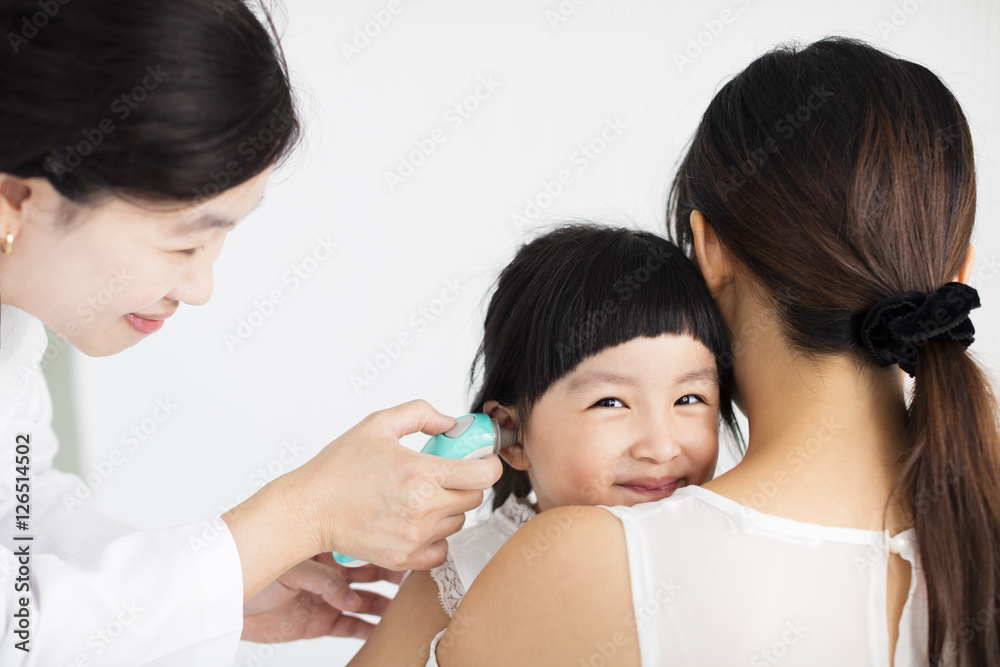 female doctor Taking temperature using in ear thermometer