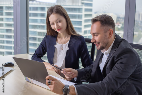 business woman discusses the report with his colleague at work
