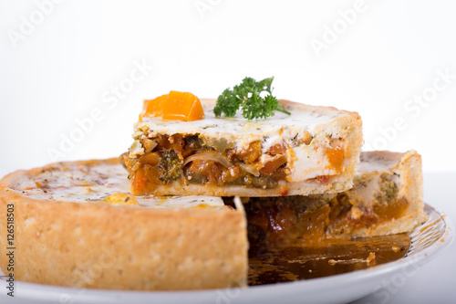 vegetable pie on a plate, white background, studio photo