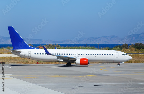 plane was taxiing for takeoff on background of sea and mountains, Greece Rhodes