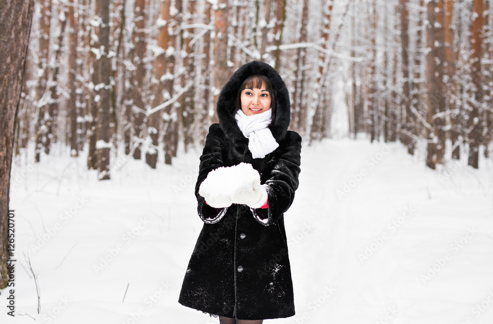 young woman in fur coat outdoors in snow garden young woman in fur coat outdoors in snow garden