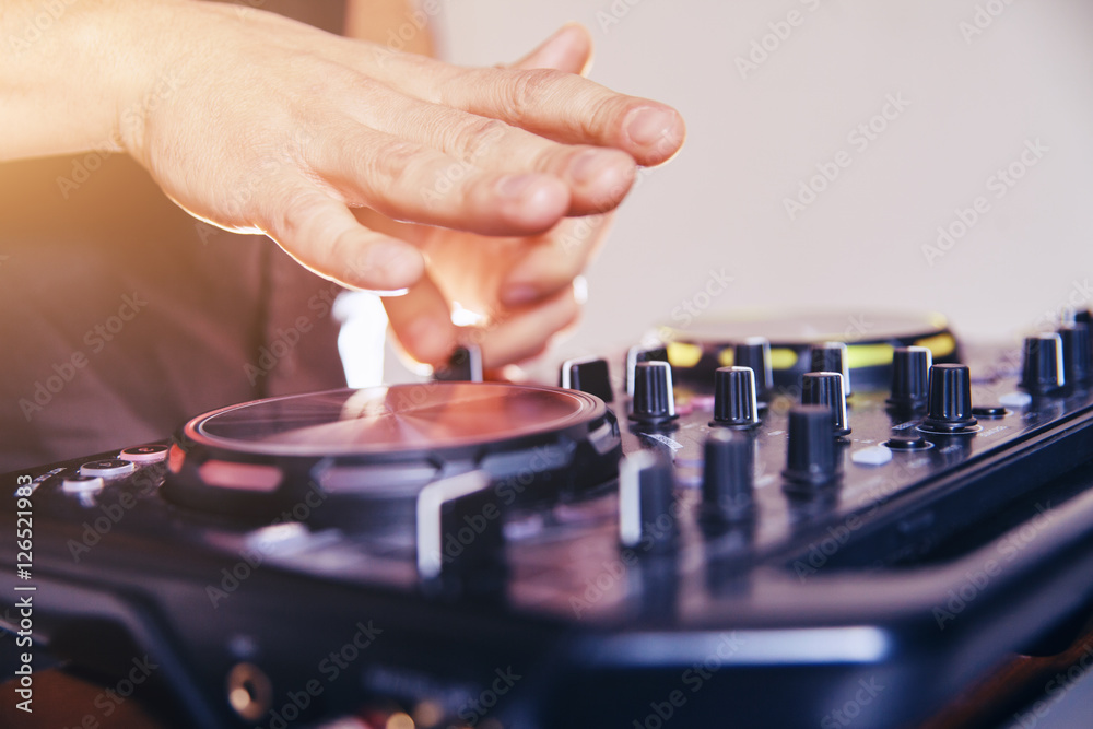DJ turntable console mixer controlling with two hand in concert nightclub stage. DJ turntable console mixer controlling with two hand in concert nightclub stage.