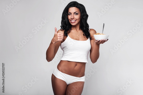 Healthy fitness woman eating quick breakfast