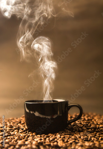 Obraz na płótnie still life of warm black cup of coffee on  roasted coffee beans