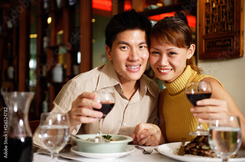 Couple in restaurant  smiling at camera